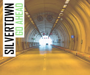 IMAGE OF CAR TRAFFIC TUNNEL IN DIM YELLOW LIGHT WITH QUOTE - 'SILVERTOWN GO AHEAD'