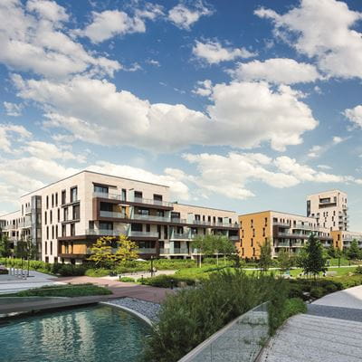 Modern block of flats overlooking gardens and man-made lake